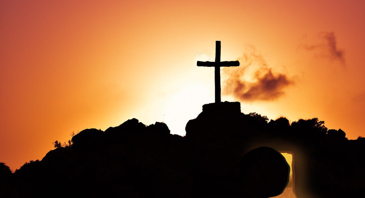 Cross over empty tomb against sunset