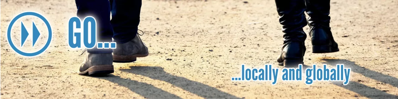 Go locally and globally text and graphic over image the feet of two people waking